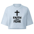 Light blue garment-dye cropped t-shirt with black cross graphic and 'Faith Over Fear' text, boxy fit, 6.5oz cotton, women's streetwear